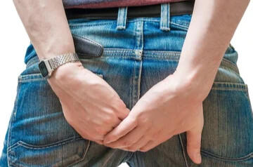 Guy holding his pants